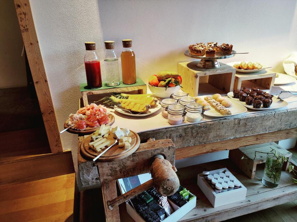 a buffet with food and drinks on a table at Chalet Le Coccole in Sappada