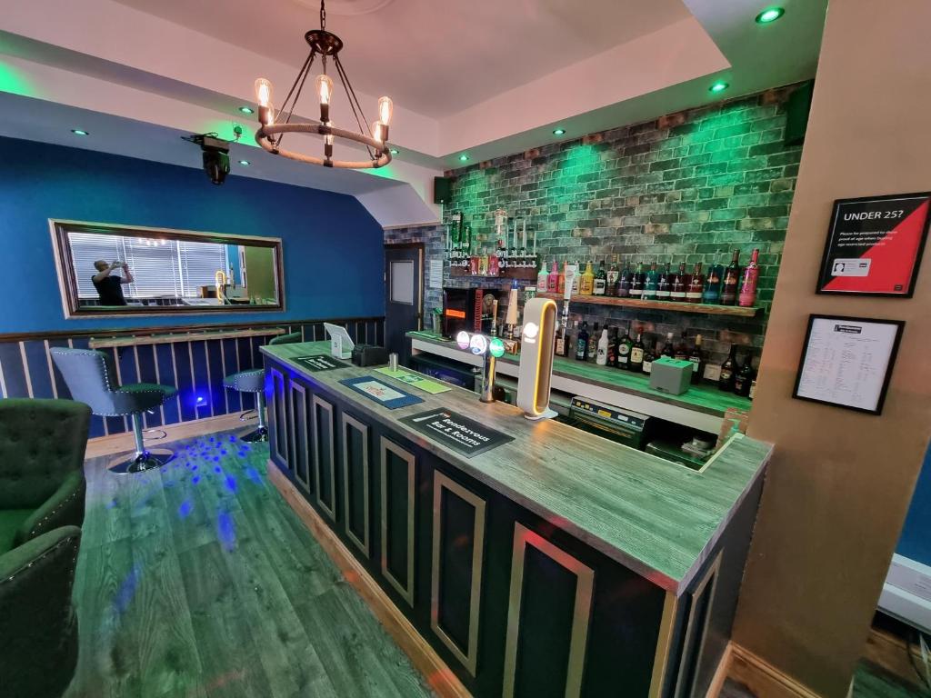 a bar with a green counter in a room at Rendezvous Bar & Rooms - ADULTS ONLY in Blackpool