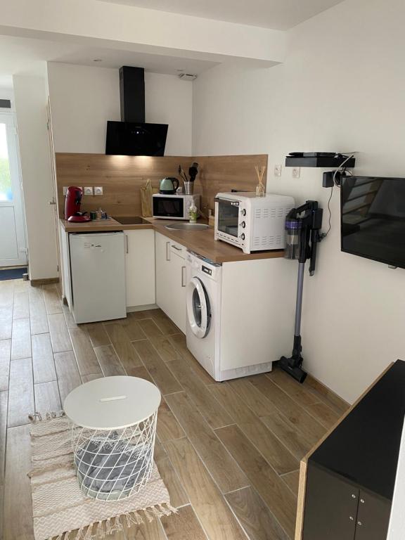 a small kitchen with a microwave and a stove at Gîte Adaméo in Yport