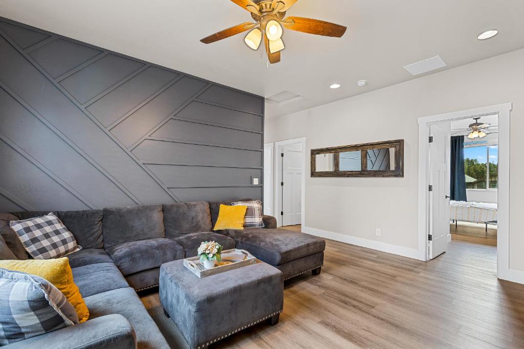 a living room with a couch and a ceiling fan at Serene Escape - Close to Sedona and Grand Canyon in Flagstaff