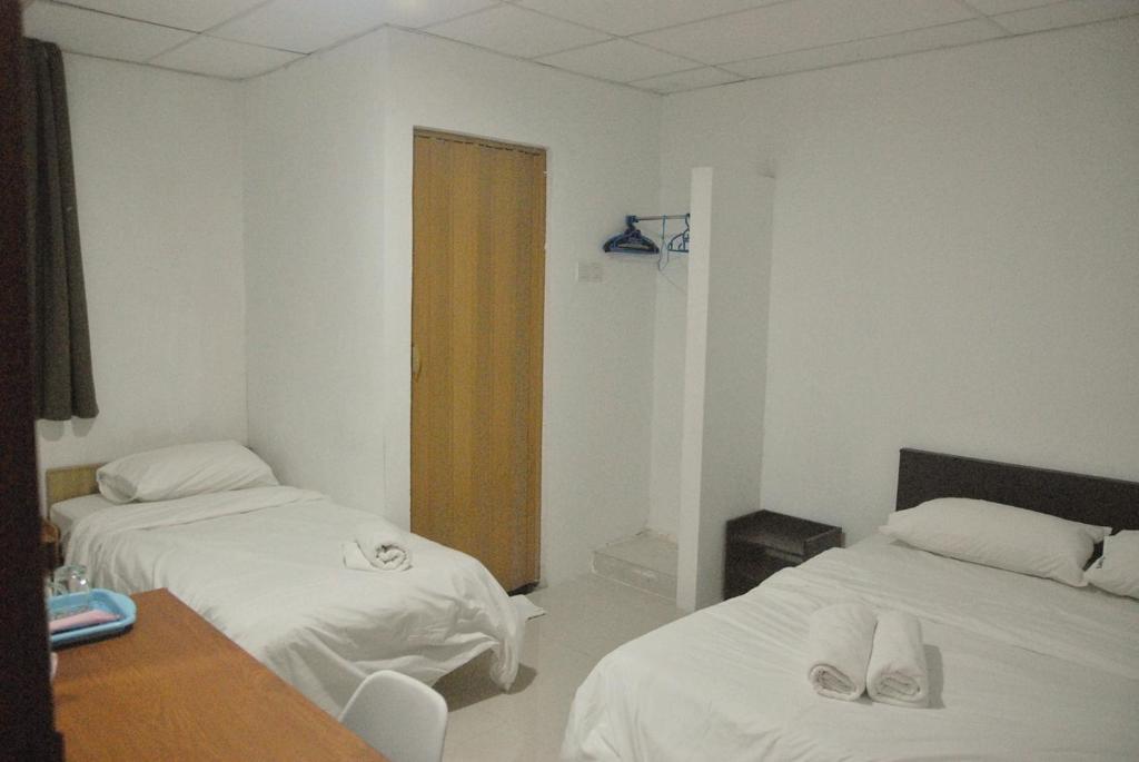 Postel nebo postele na pokoji v ubytování Tang Hotel