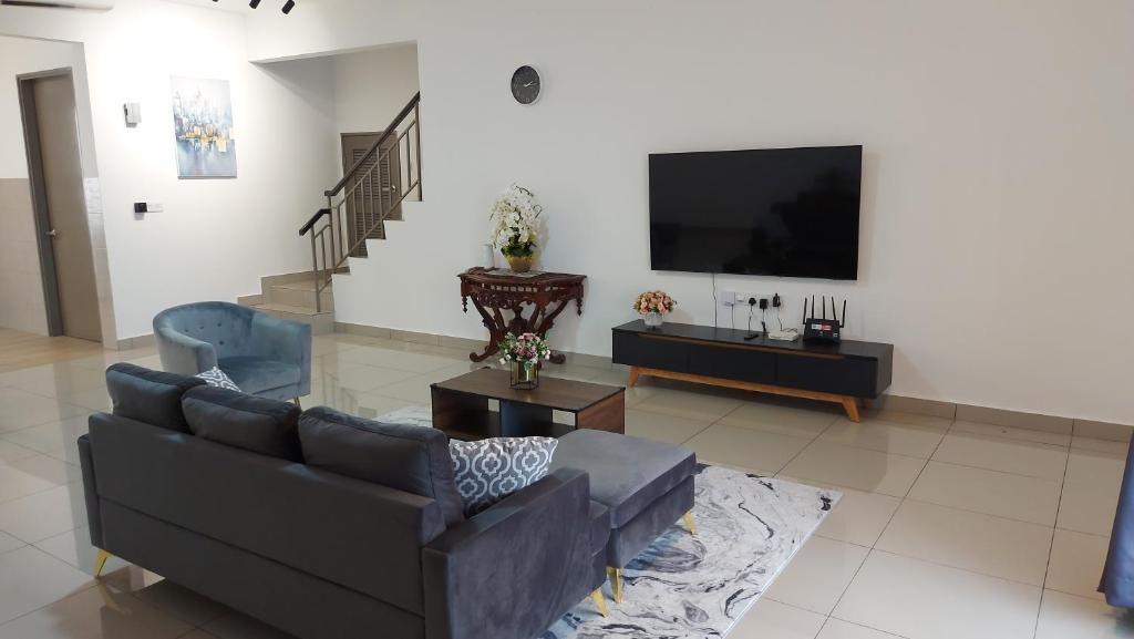 a living room with a couch and a flat screen tv at TL145 The Strata in Kajang