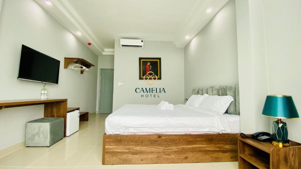 a bedroom with a bed and a flat screen tv at Camelia 108 Le Lai Hotel in Ho Chi Minh City