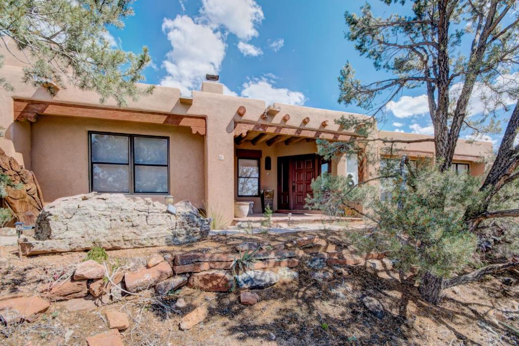 a home in the desert with trees at Moonstar, 4 Bedrooms, Sleeps 10, Pet Friendly, Fireplace, Views, WiFi in Santa Fe