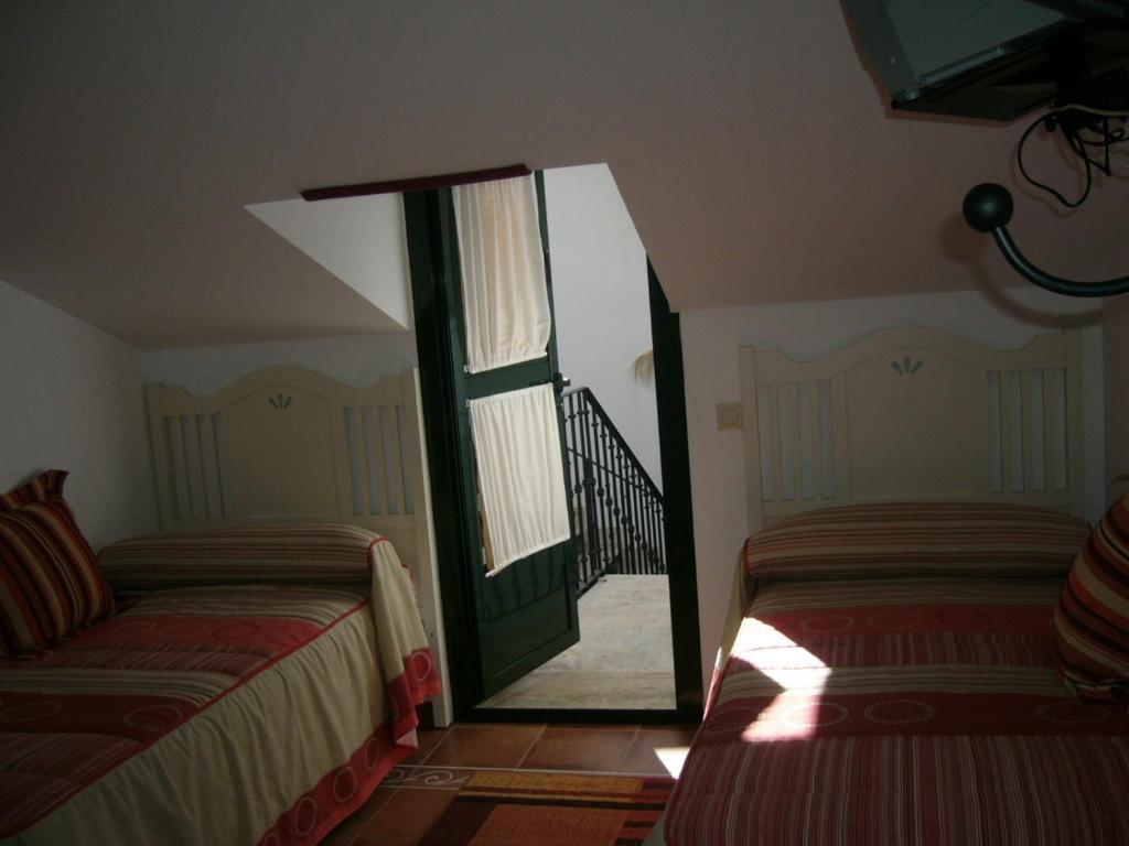 A bed or beds in a room at Casa Rural Morada Maragata
