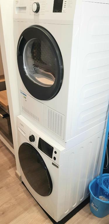 a white washer and dryer sitting next to each other at Escapade Niortaise - Studios climatisés hyper-centre de Niort in Niort