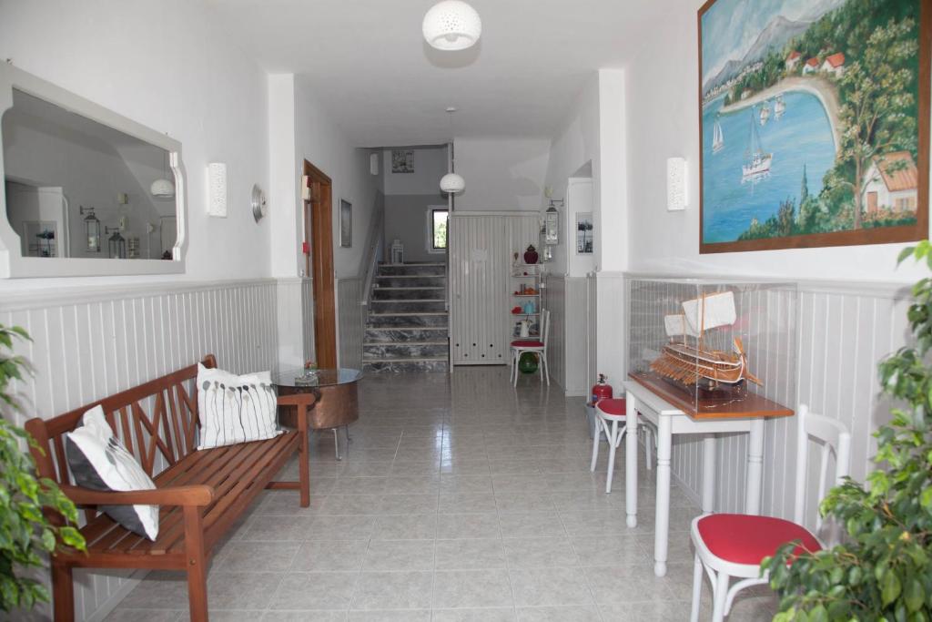 a hallway with benches and a table and stairs at Villa Veneti in Néos Pírgos