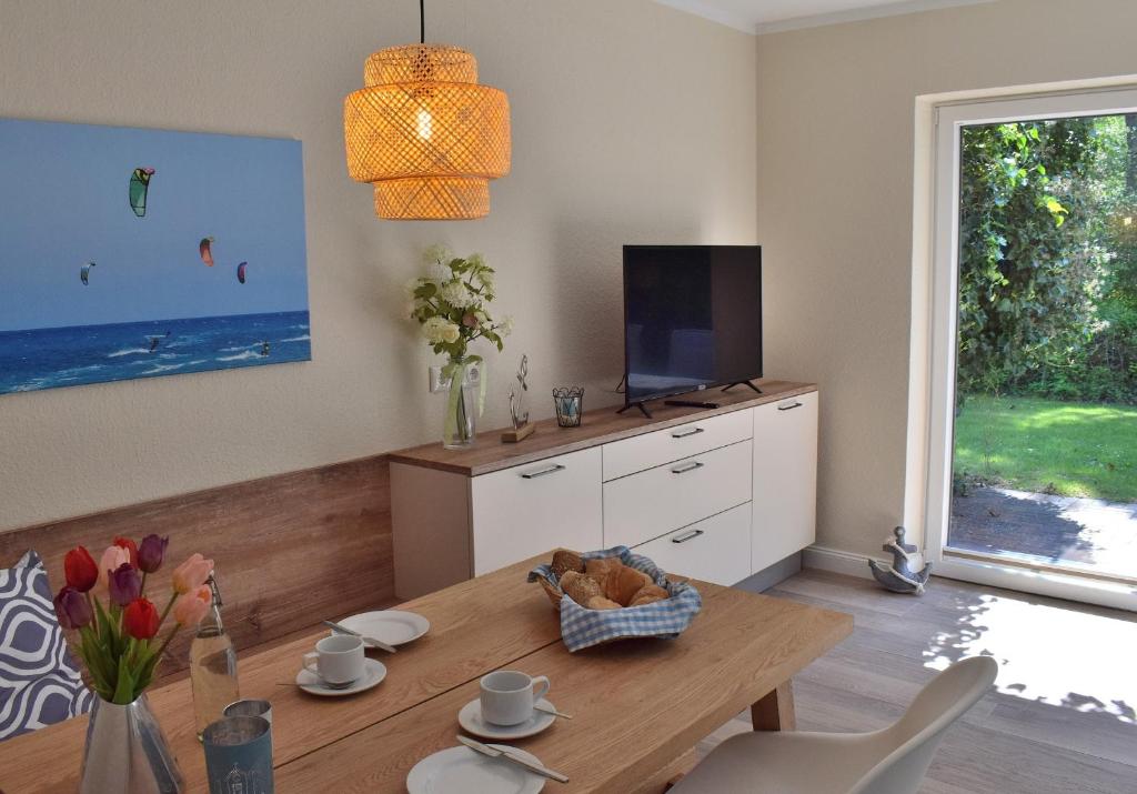 a living room with a table and a tv at Am Hof 4 in Staberdorf