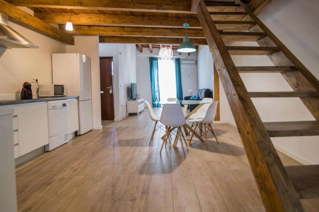 a kitchen and dining room with a wooden staircase at Cozy Duplex Apartment 1 step to City Center SelfCheckin! in Valencia
