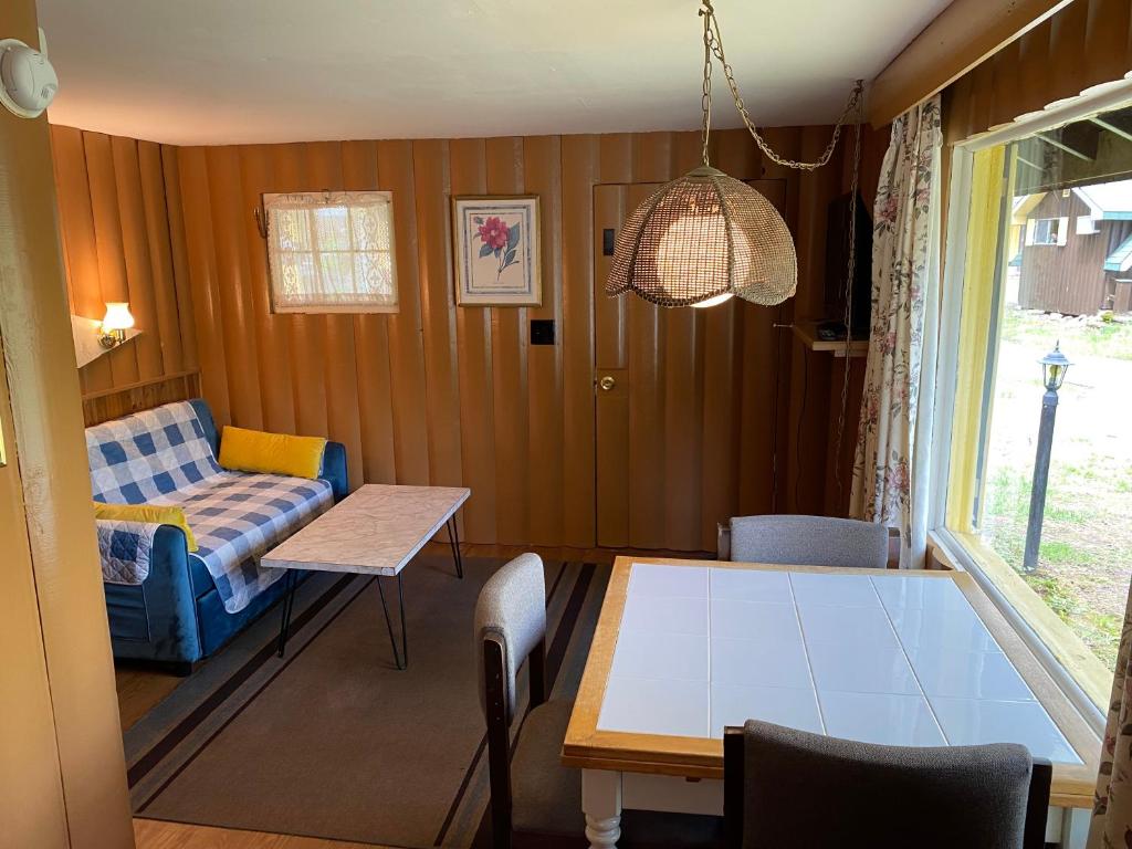 a living room with a table and a couch at Amber Lantern One-Bedroom Cottage in Lake George