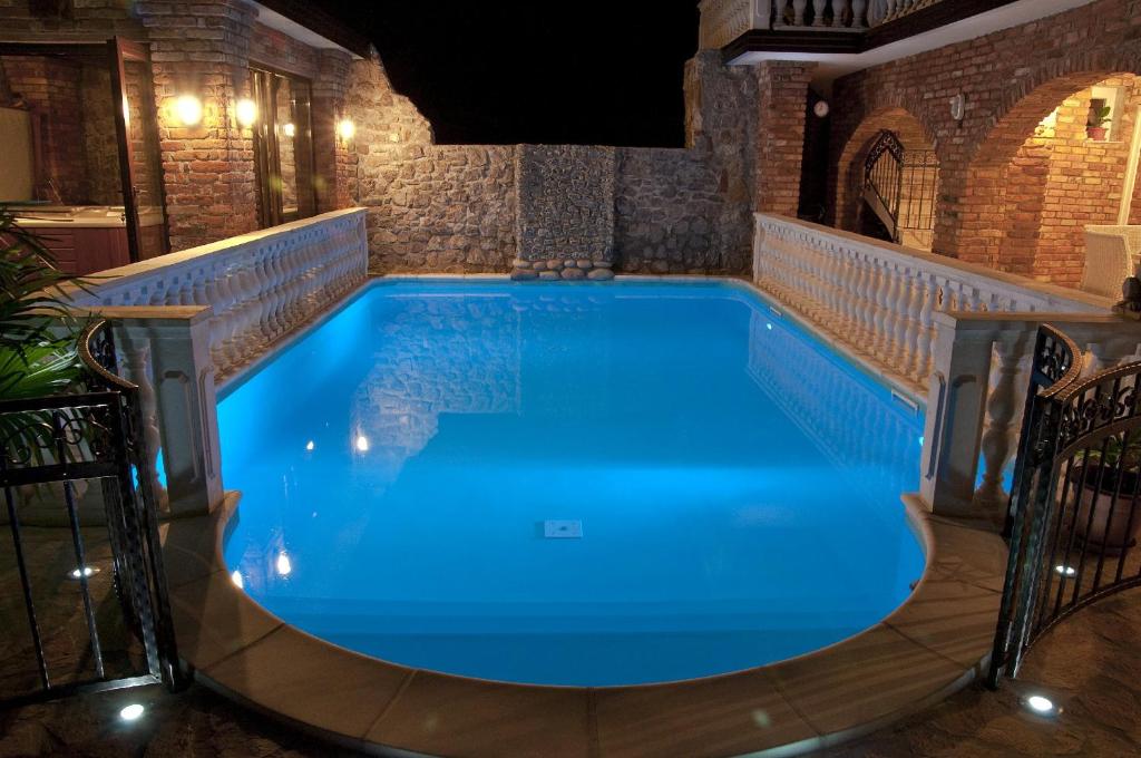 a large swimming pool in a house at night at Casa Oasa in Marezige