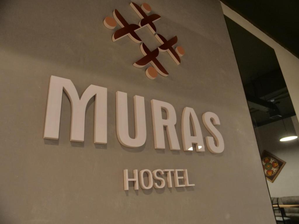 a sign for a mufas hosler hospital at Muras Hostel in Bishkek
