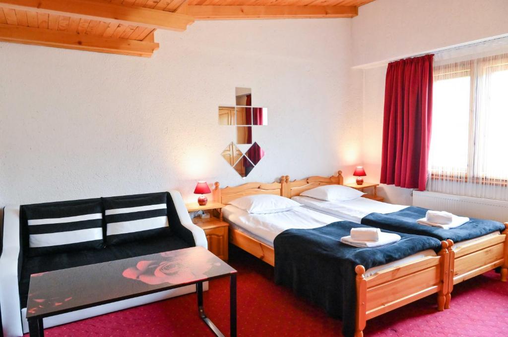 a hotel room with two beds and a chair at Discovery Apartment Bansko in Bansko