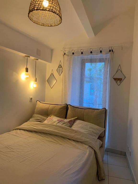 a bedroom with a large bed with a window at TinyHouse in La Roquette-sur-Siagne