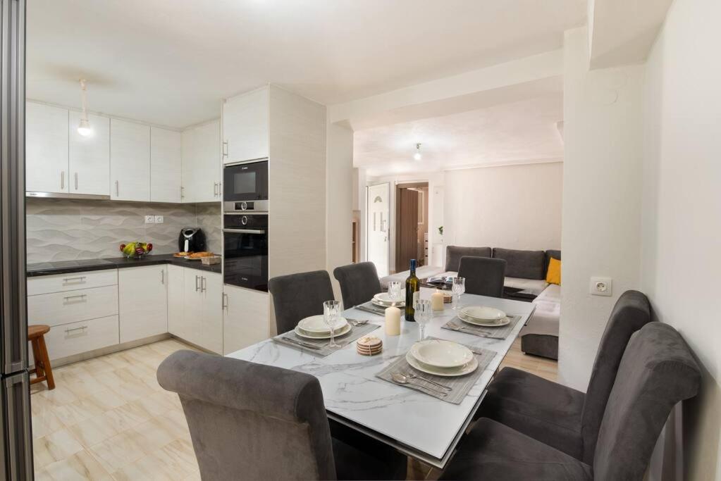 a kitchen and a dining room with a table and chairs at Porto Gaios House in Gaios