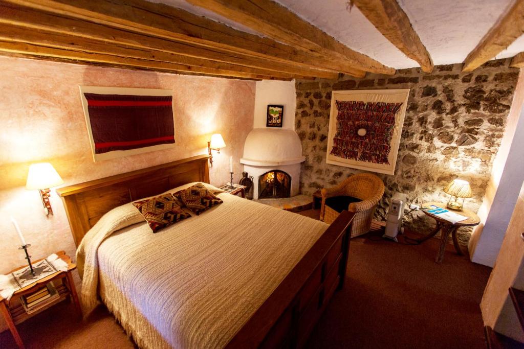 Postel nebo postele na pokoji v ubytování Hacienda Cusin