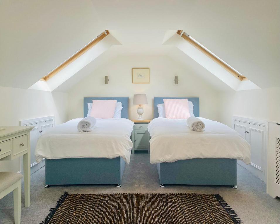 a bedroom with two beds and a desk in a attic at The Lemon Grove, Leyburn in Leyburn