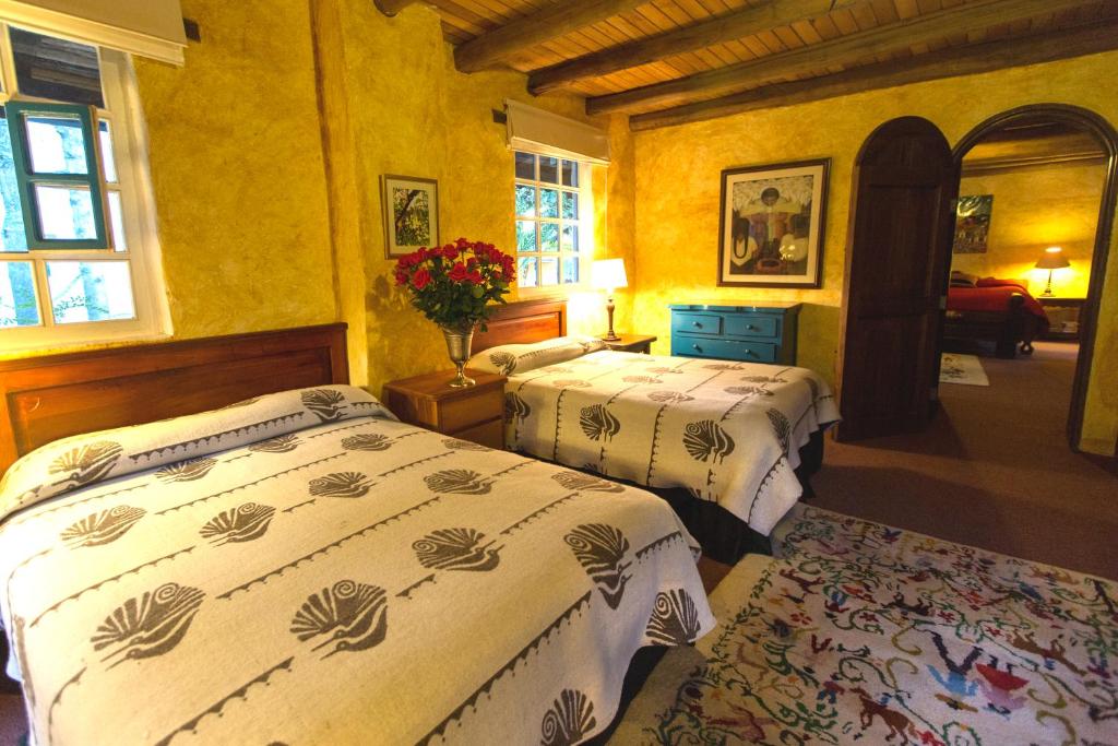 Postel nebo postele na pokoji v ubytování Hacienda Cusin