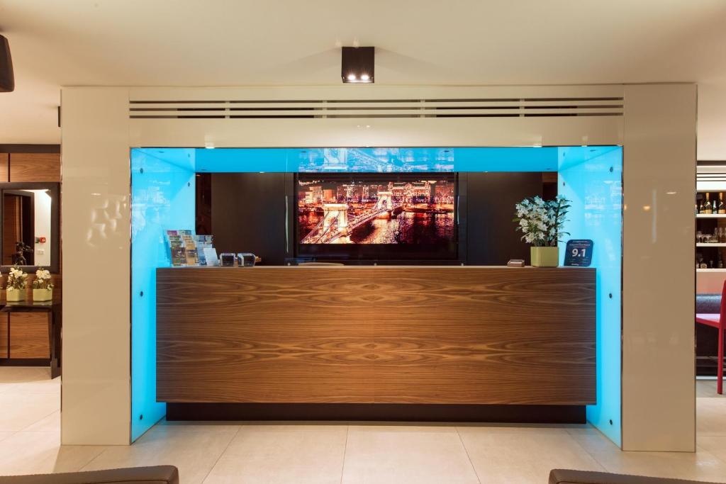 a bar in a restaurant with blue lights at Boutique Hotel Victoria Budapest in Budapest