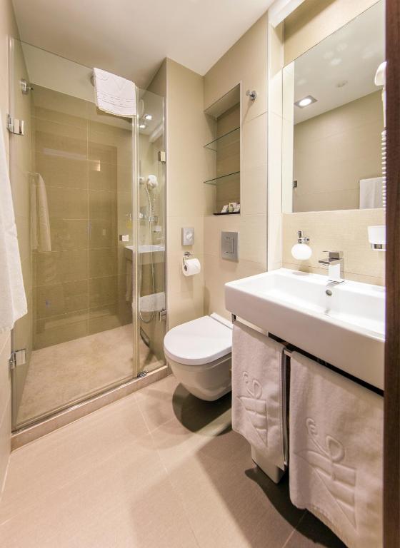 a bathroom with a toilet and a sink and a shower at Boutique Hotel Victoria Budapest in Budapest