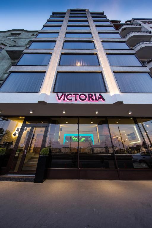 a tall building with a sign on the side of it at Boutique Hotel Victoria Budapest in Budapest