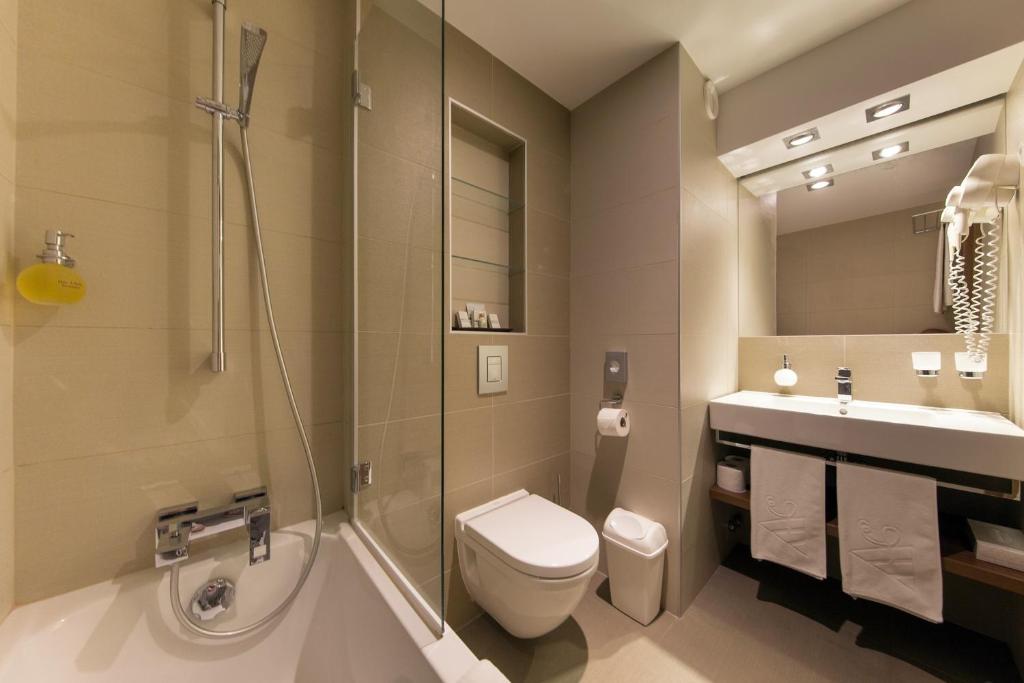 a bathroom with a toilet and a sink and a shower at Boutique Hotel Victoria Budapest in Budapest