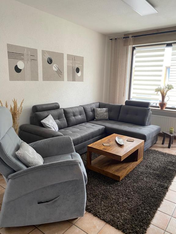 a living room with a couch and a coffee table at Ferienwohnung Laura in Bremm