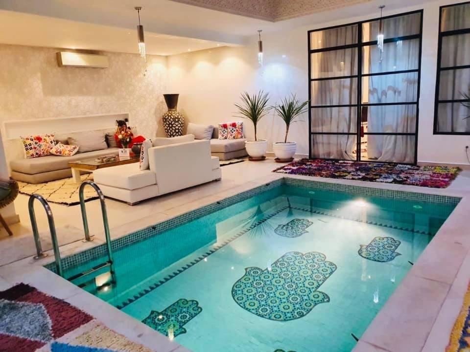 a living room with a swimming pool in a house at Riad Tsar Mimoun in Marrakesh