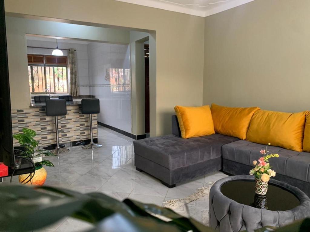 a living room with a couch and a table at Luxury M Apartments in Kampala