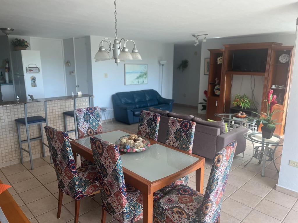 a kitchen and living room with a table and chairs at Relaxing Hillside Village Apartment in Rio Grande