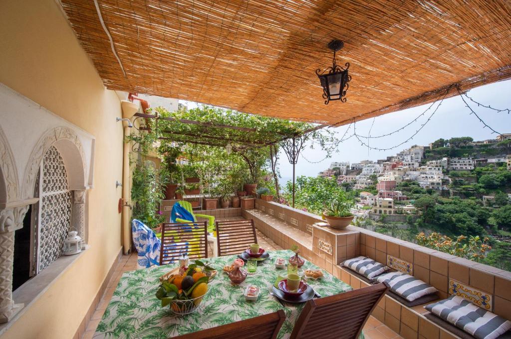 a balcony with a table and a view of a city at Casa La Bifora Positano in Positano