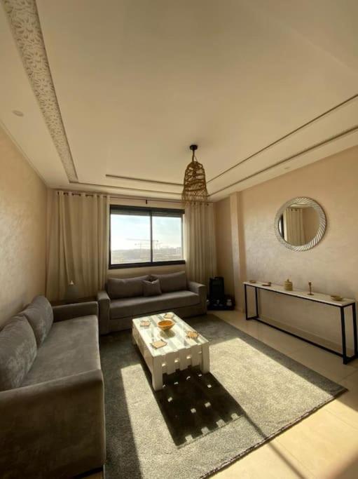 a living room with a couch and a table at CosyApp in Agadir