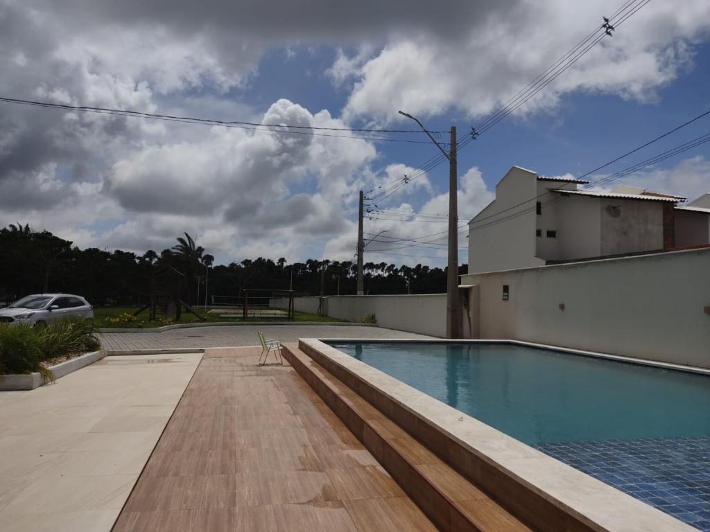 a swimming pool on the side of a house at Lençóis Confort - Apartamento in Barreirinhas