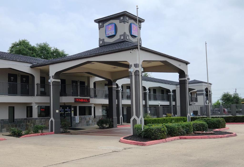 a building with a clock tower on top of it at Express Inn Tomball in Tomball