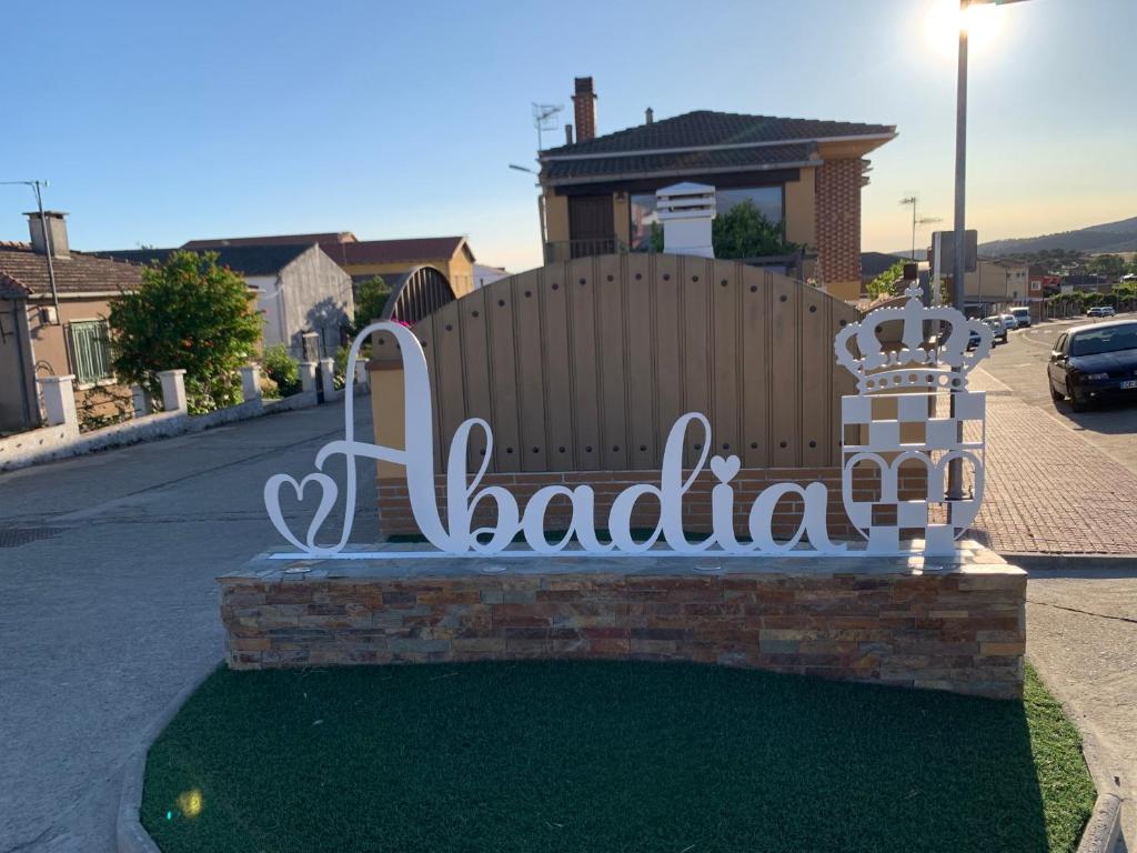 a bench with the wordaldoria sitting on a street at El Encanto de Abadía in Abadía