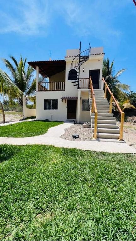 a house with a staircase in front of it at Los Amores Apartments A in Pérula