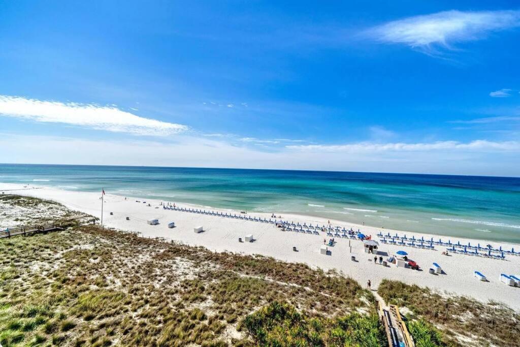 an aerial view of a beach with chairs and umbrellas at Your Ultimate Beachfront retreat! Brand New Flooring!! in Panama City Beach