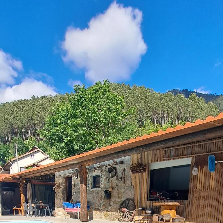 a building with a flat screen tv on top of it at Casa do Garrano - Gerês in Vilar da Veiga