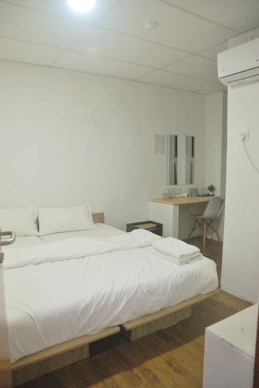 Postel nebo postele na pokoji v ubytování Tang Hotel
