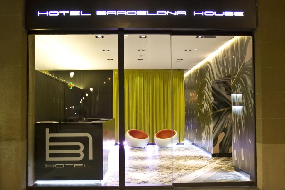 a store front with two chairs in front of a window at Barcelona House in Barcelona