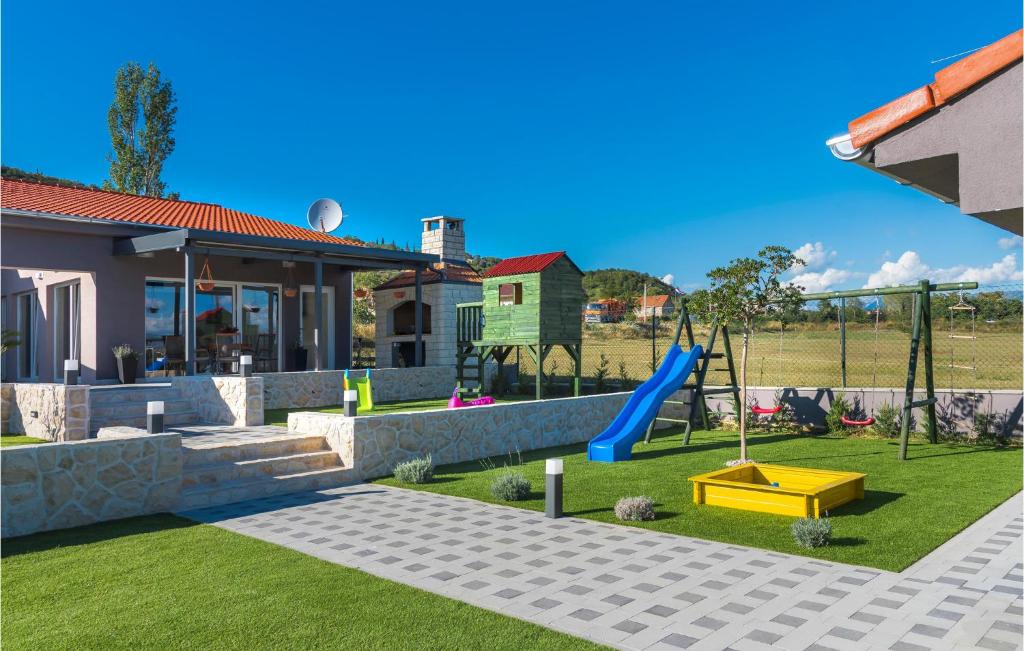 a backyard with a playground with a slide at Stunning Home In Siveric With 5 Bedrooms, Jacuzzi And Outdoor Swimming Pool in Siverić