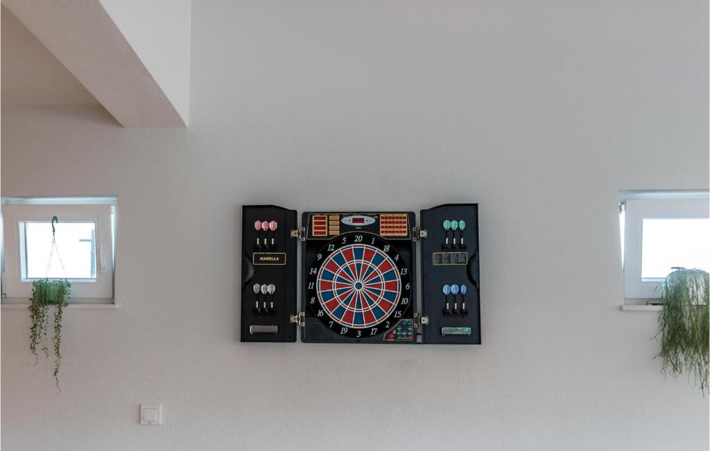 a dart board on a wall in a room at Stunning Home In Siveric With 5 Bedrooms, Jacuzzi And Outdoor Swimming Pool in Siverić