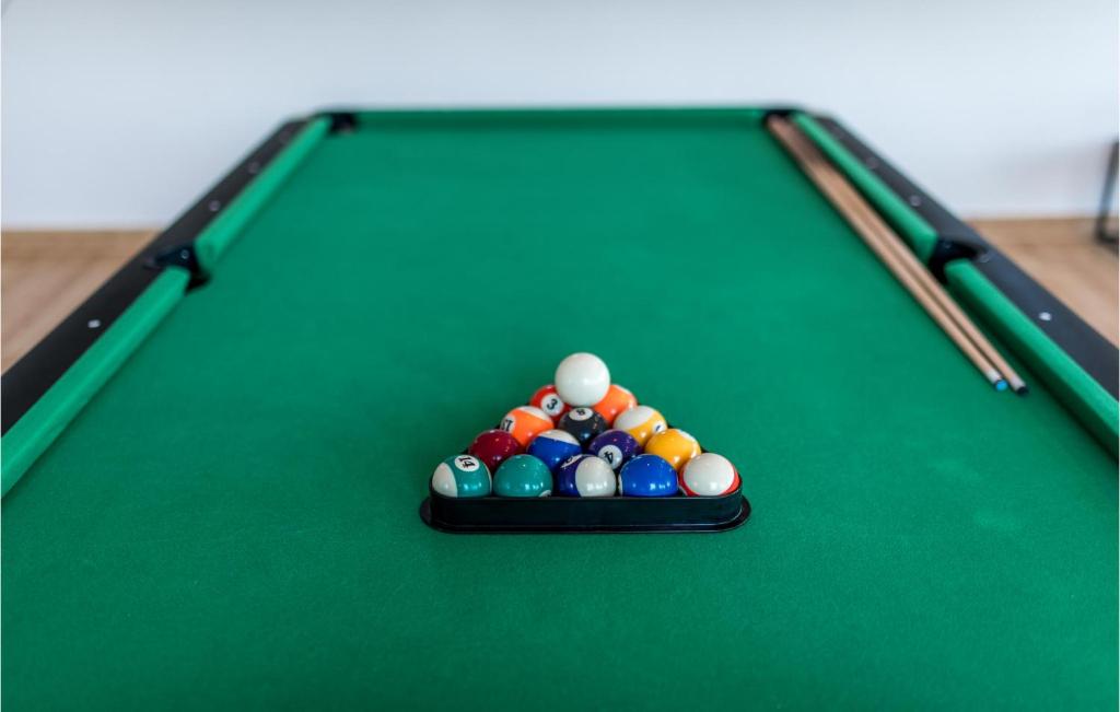 a group of cue balls on a pool table at Stunning Home In Siveric With 5 Bedrooms, Jacuzzi And Outdoor Swimming Pool in Siverić