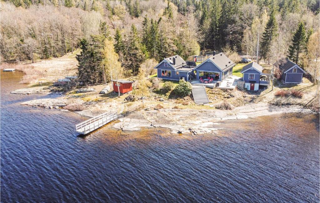 an aerial view of a house on an island in the water at Lovely Home In Trollhttan With House Sea View in Trollhättan