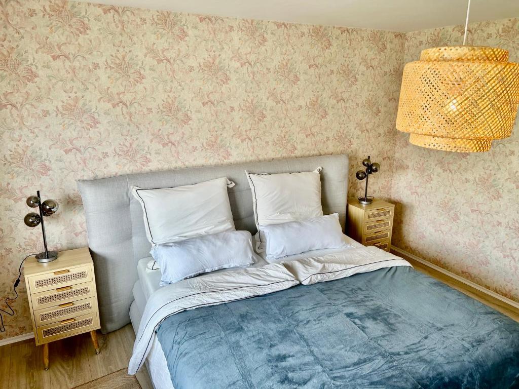 a bedroom with a bed and two night stands at RelaxStay - Balkon - Smart-TV - WIFI in Dielheim