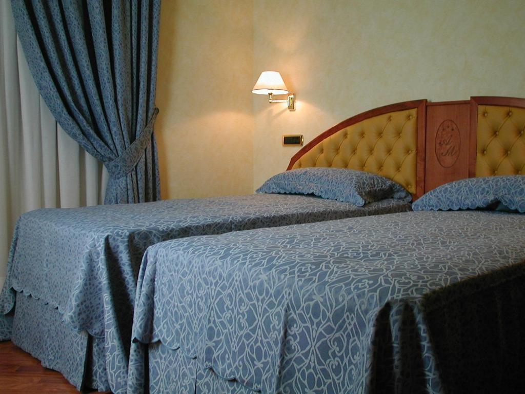 Postel nebo postele na pokoji v ubytování Hotel Antico Masetto