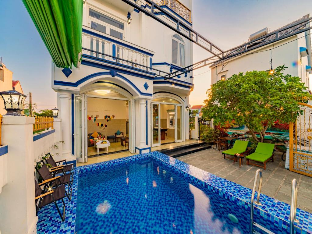 a house with a swimming pool in a yard at HA An Bang Pool Villa in Hoi An