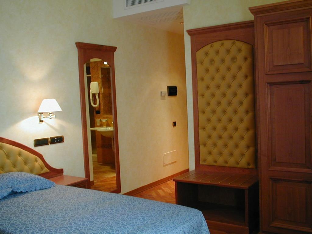 Postel nebo postele na pokoji v ubytování Hotel Antico Masetto