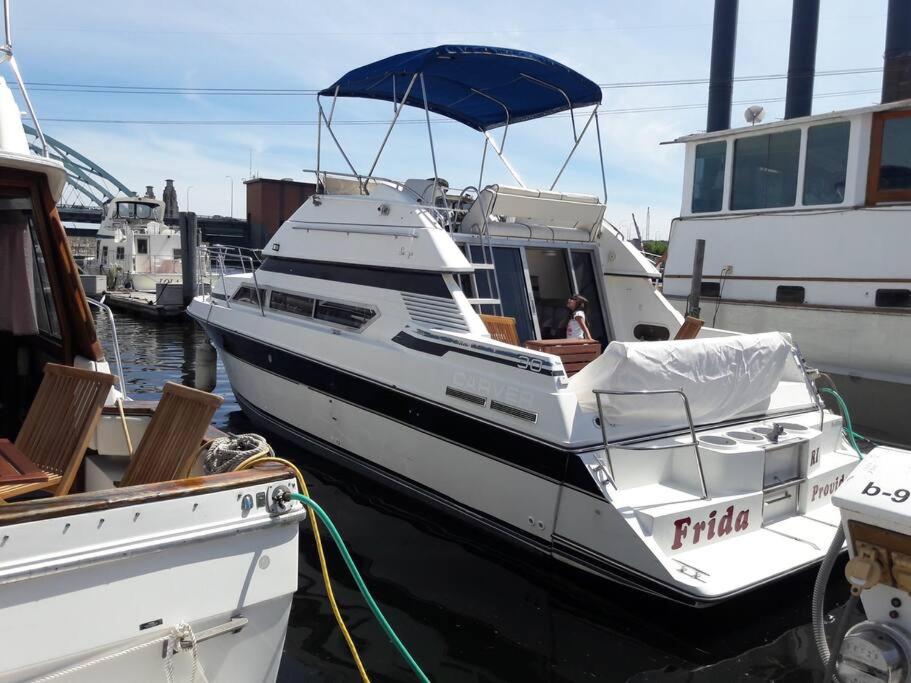 a white boat is docked at a dock at Yacht Stay Providence Marina in Providence