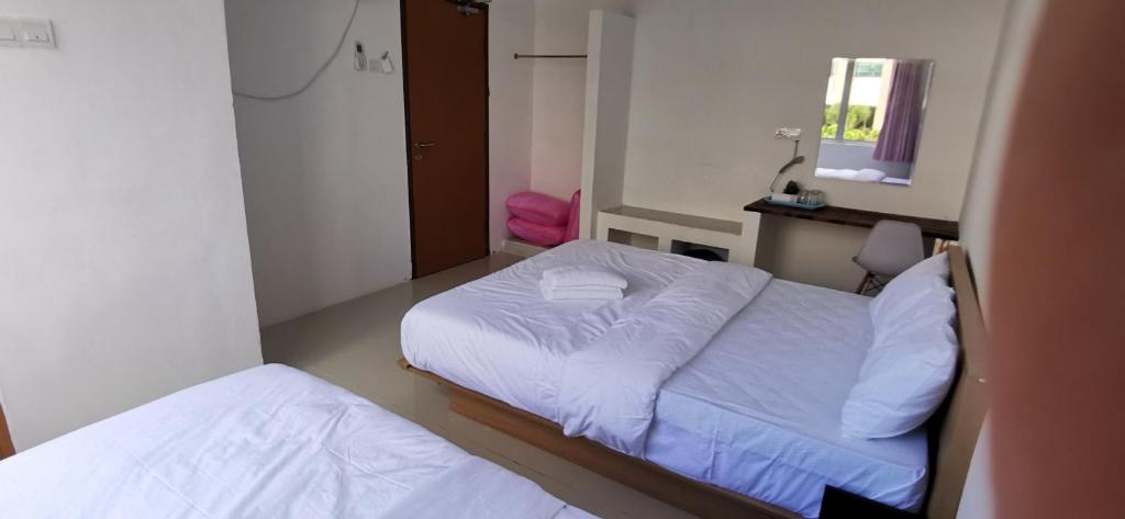 Postel nebo postele na pokoji v ubytování Tang Hotel